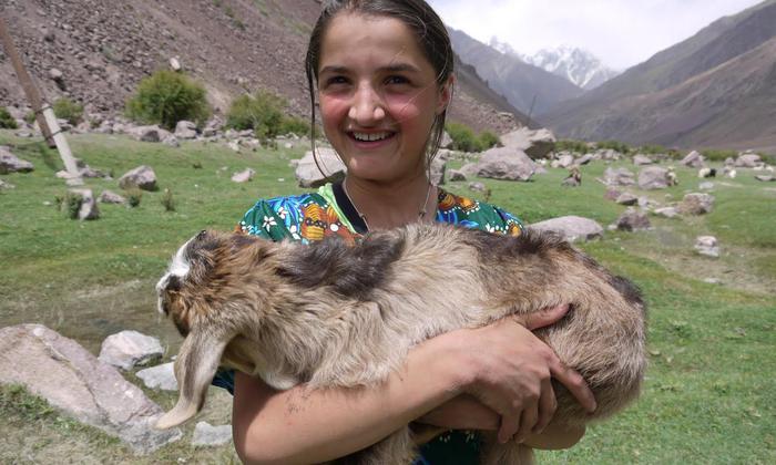 A girl from Bartang valley, Pamir with her goat kid